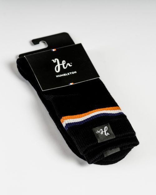 Black padel sock with woven labels on the sides and Victory Flag embroidered on the leg